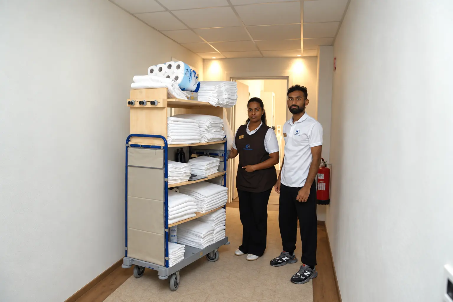 SETECNO SERVIZI SRLS professionals beside a prepared linen cart